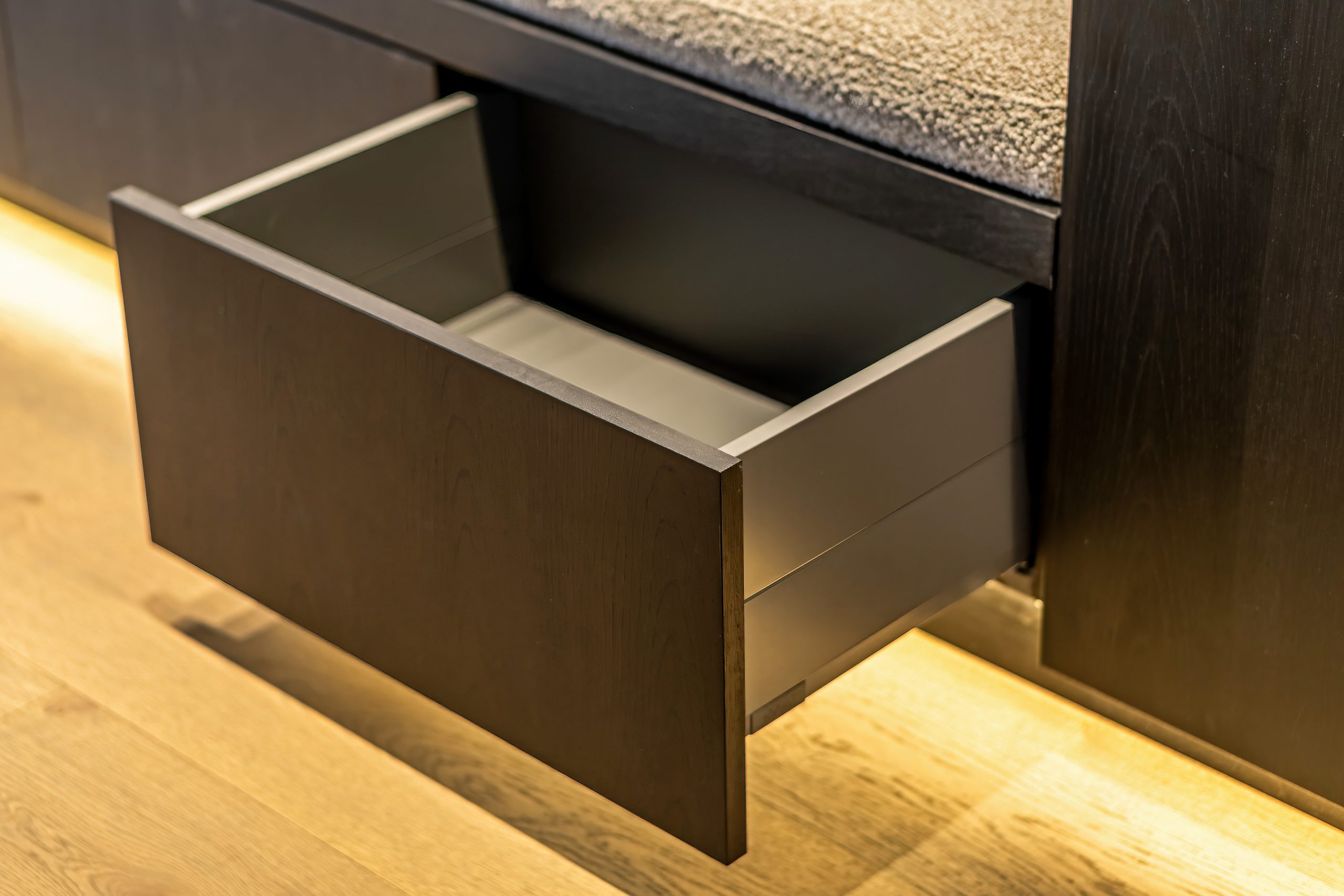 Under the bench storage. Custom cabinet hidden storage drawer