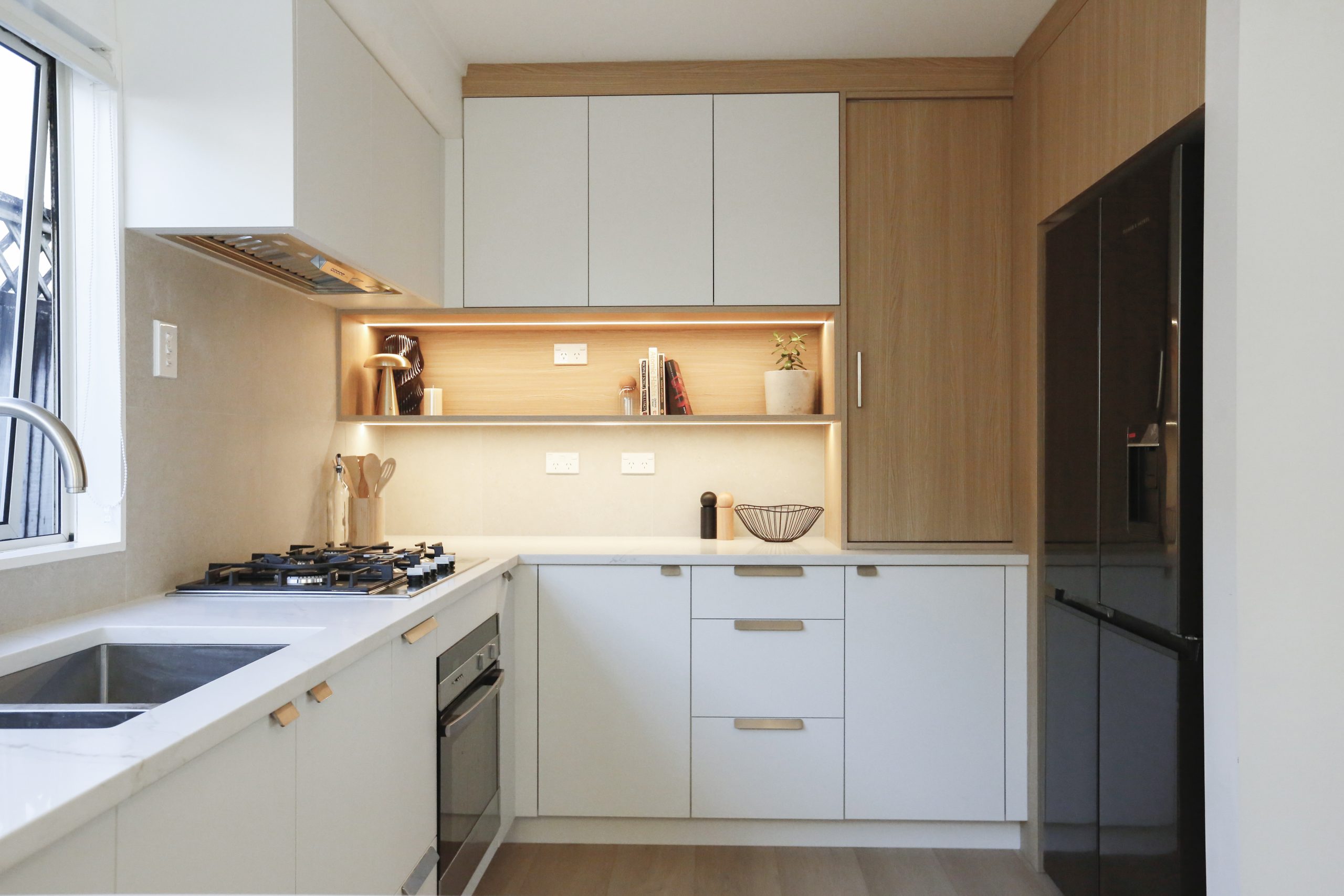 Modern white and light woodgrain kitchen U-shaped design