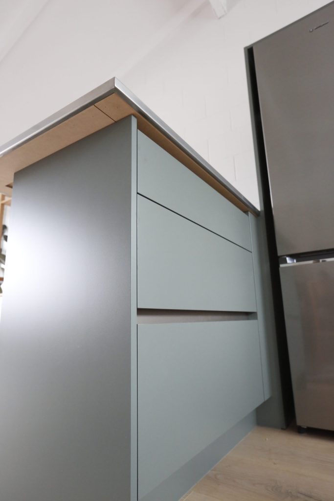 Dark green modern kitchen with stainless steel benchtop in Auckland New Zealand