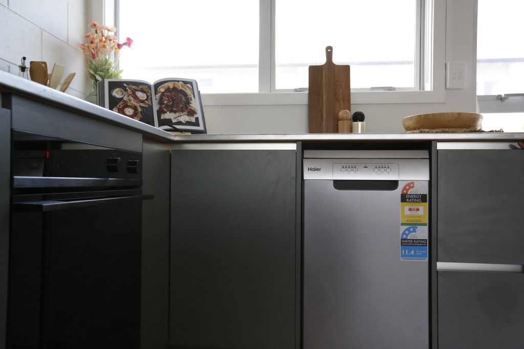 Dark green modern kitchen with stainless steel benchtop in Auckland New Zealand