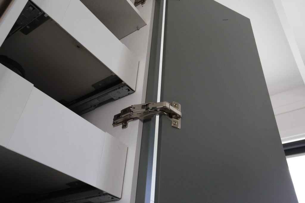 Dark green modern kitchen with stainless steel benchtop in Auckland New Zealand