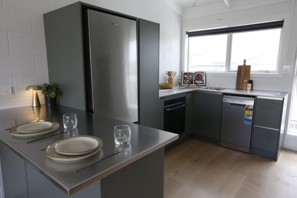 Dark green modern kitchen with stainless steel benchtop in Auckland New Zealand
