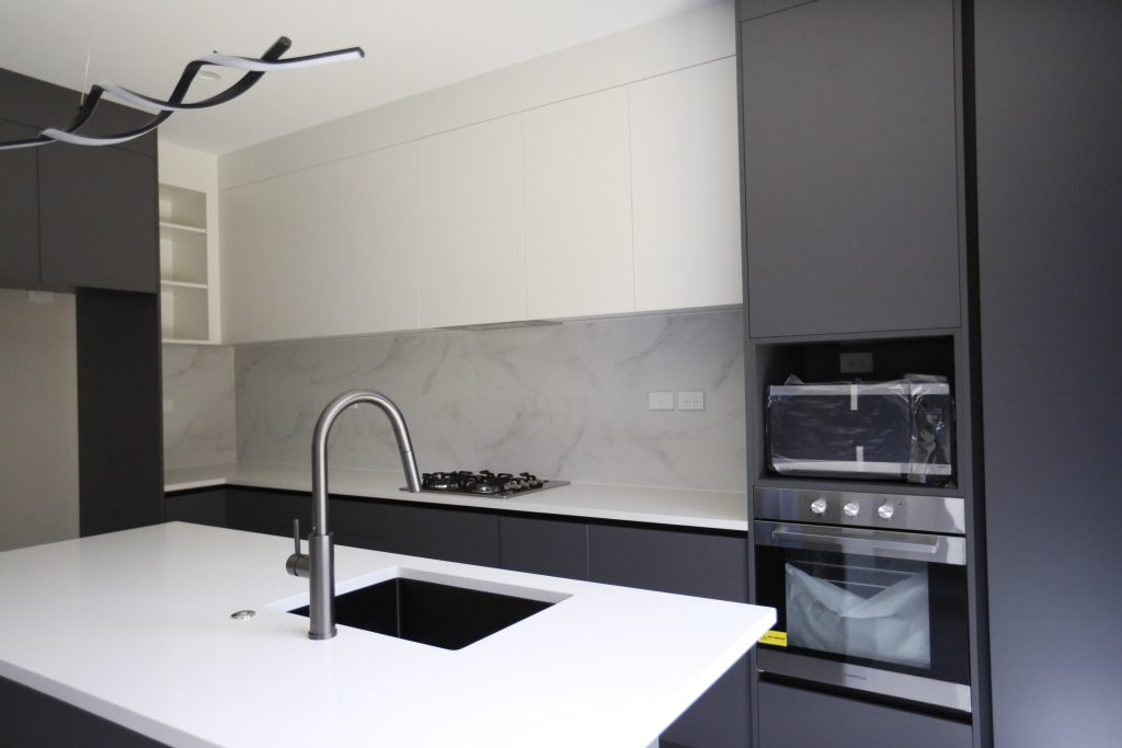A Fully Handleless Sleek Minimalist black and white Kitchen Auckland