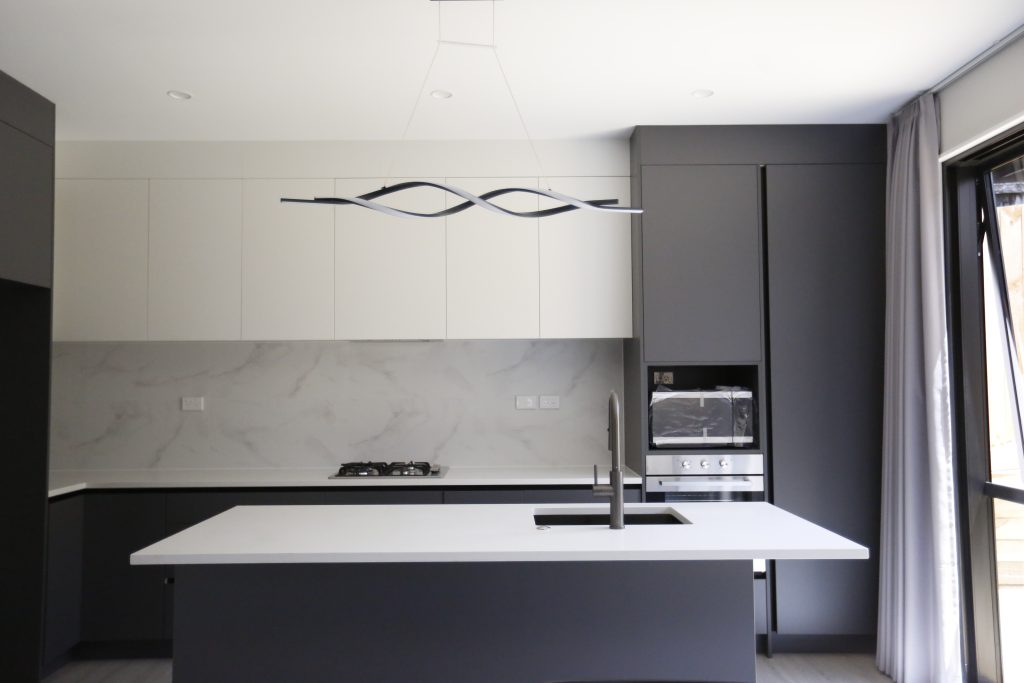 A Fully Handleless Sleek Minimalist black and white Kitchen Auckland