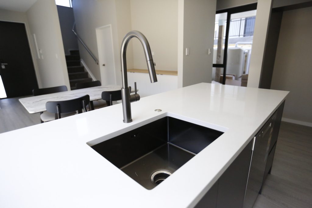 A Fully Handleless Sleek Minimalist black and white Kitchen Auckland
