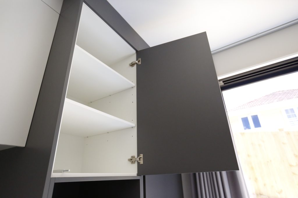 A Fully Handleless Sleek Minimalist black and white Kitchen Auckland